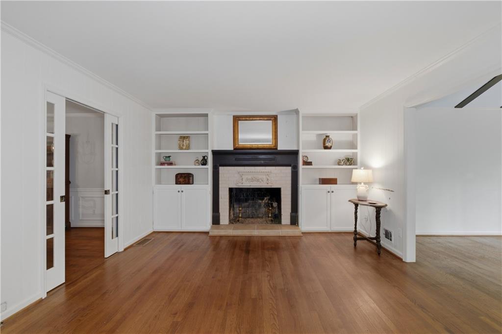 7245 Dunhill Terrace Northeast Atlanta, GA 30328 - Photo 20 of 45 a living room with a fireplace and wooden floor