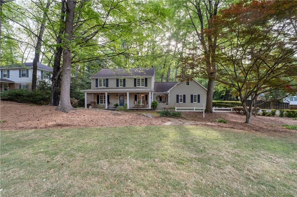7245 Dunhill Terrace Northeast Atlanta, GA 30328 - Photo 2 of 45 a front view of a house with a yard