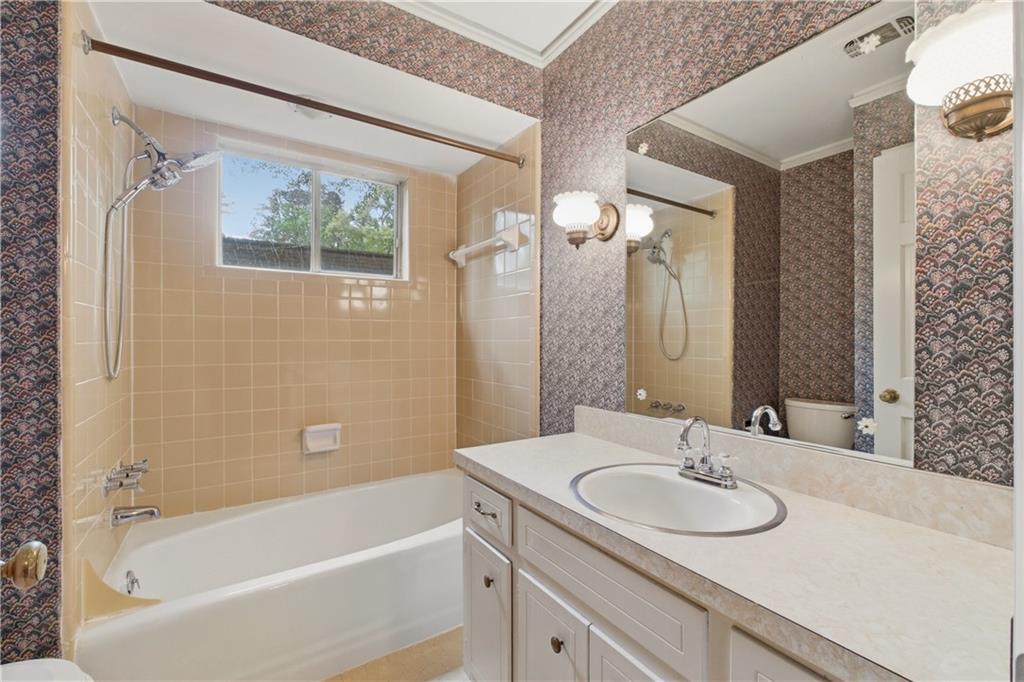 7245 Dunhill Terrace Northeast Atlanta, GA 30328 - Photo 33 of 45 a bathroom with a tub sink and mirror