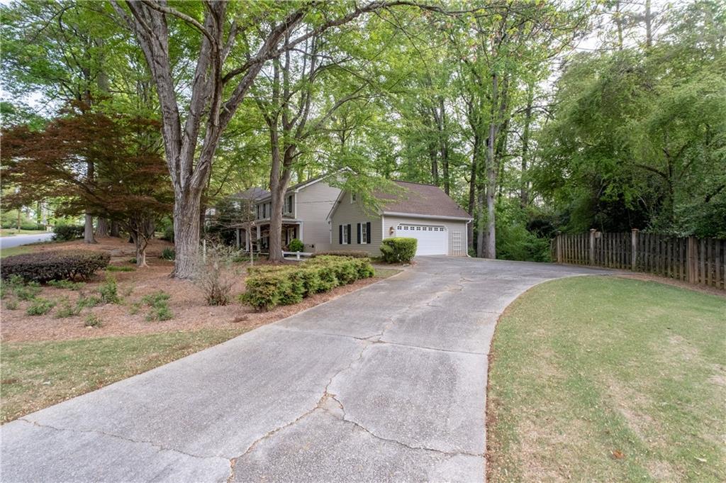7245 Dunhill Terrace Northeast Atlanta, GA 30328 - Photo 4 of 45 a front view of a house with a yard and garage