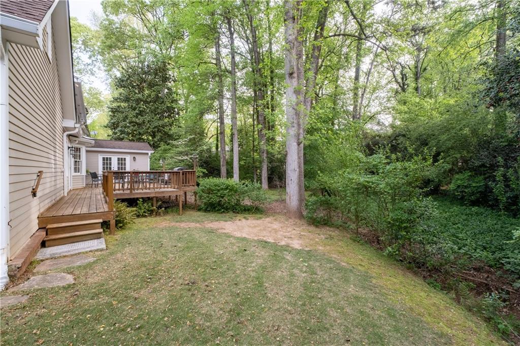 7245 Dunhill Terrace Northeast Atlanta, GA 30328 - Photo 42 of 45 a view of house with backyard outdoor seating and green space
