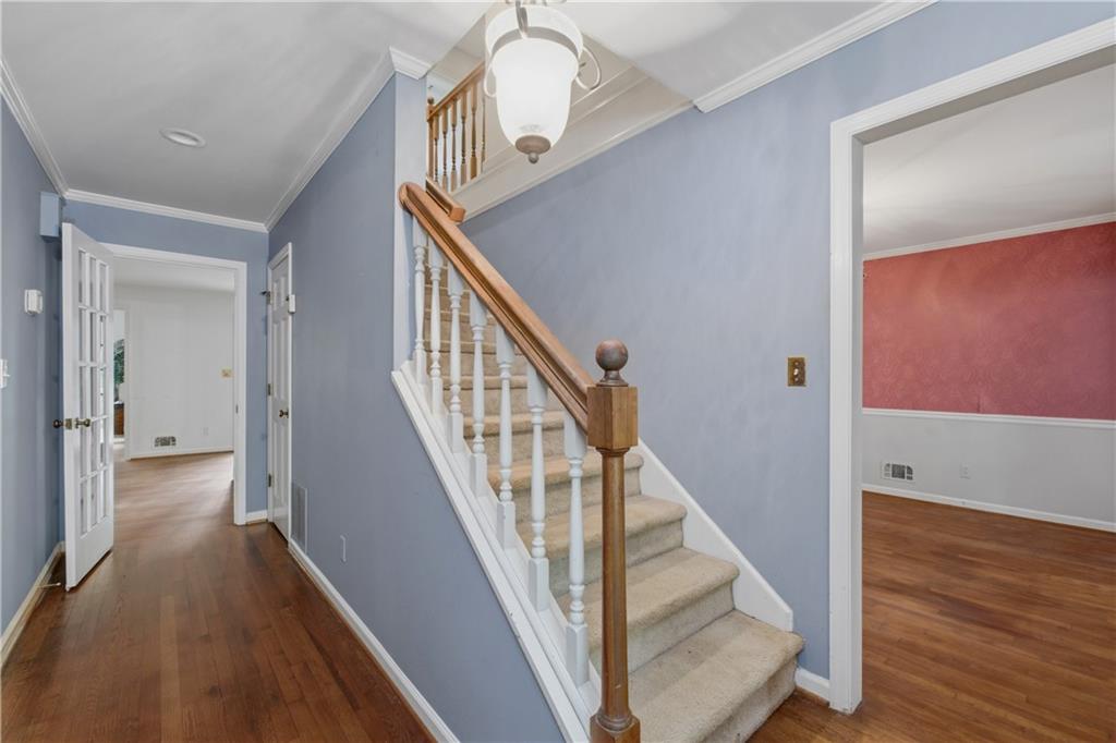 7245 Dunhill Terrace Northeast Atlanta, GA 30328 - Photo 8 of 45 a view of a hallway with wooden floor and staircase