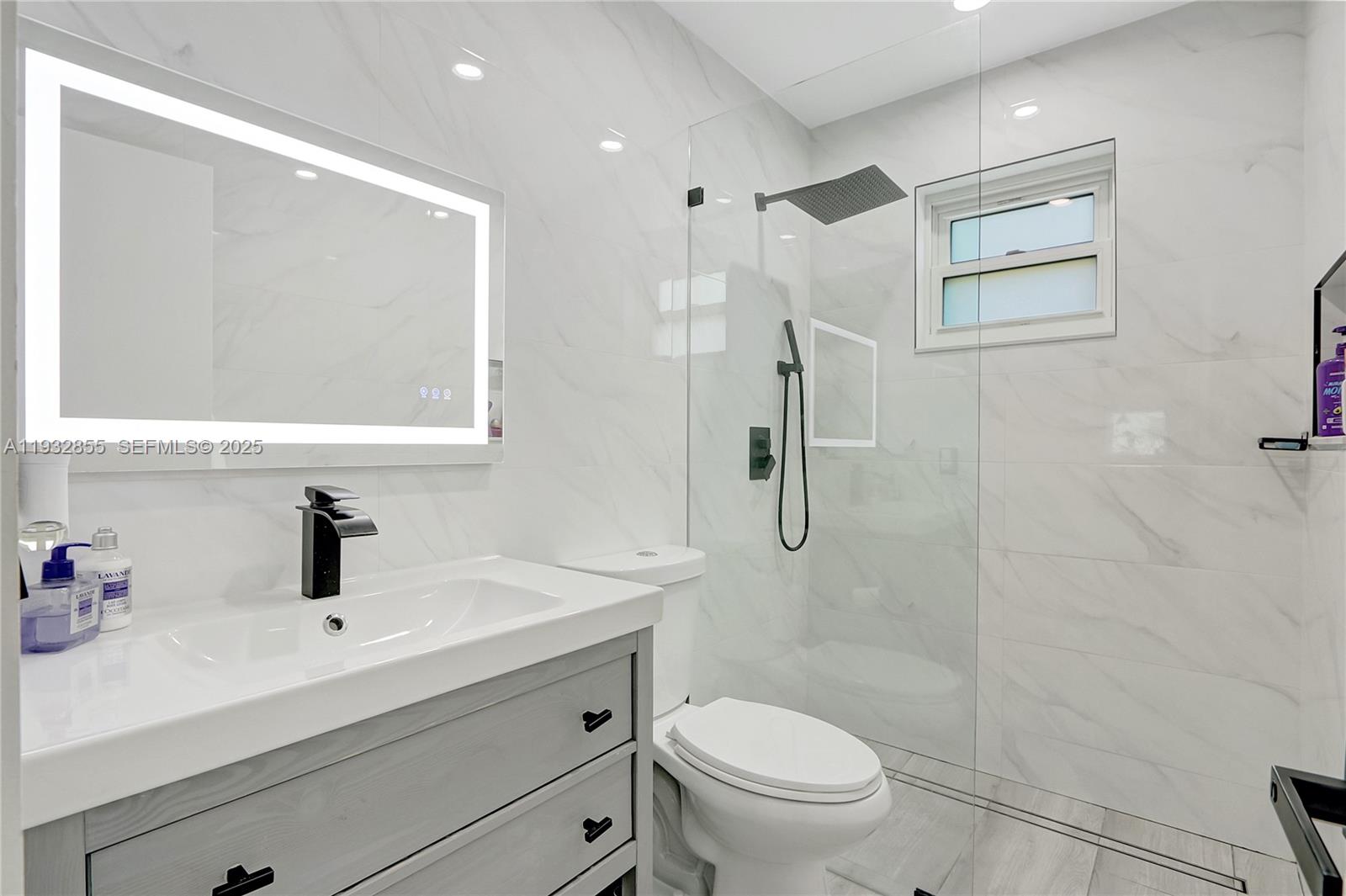 13217 Southwest 257th Terrace Homestead, FL 33032 - Photo 12 of 20 a bathroom with a sink toilet a mirror and shower