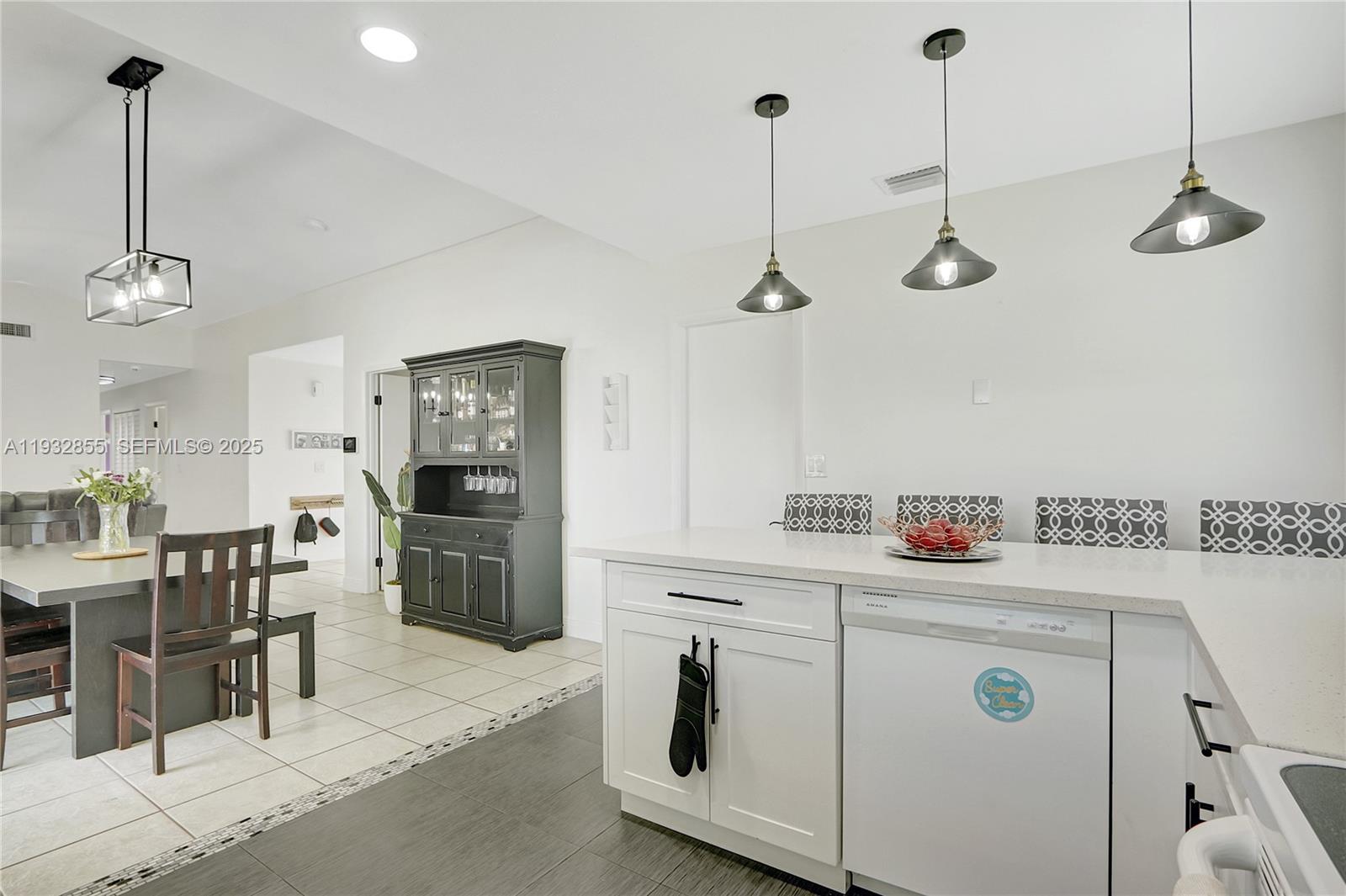13217 Southwest 257th Terrace Homestead, FL 33032 - Photo 2 of 20 a kitchen with white cabinets and white appliances