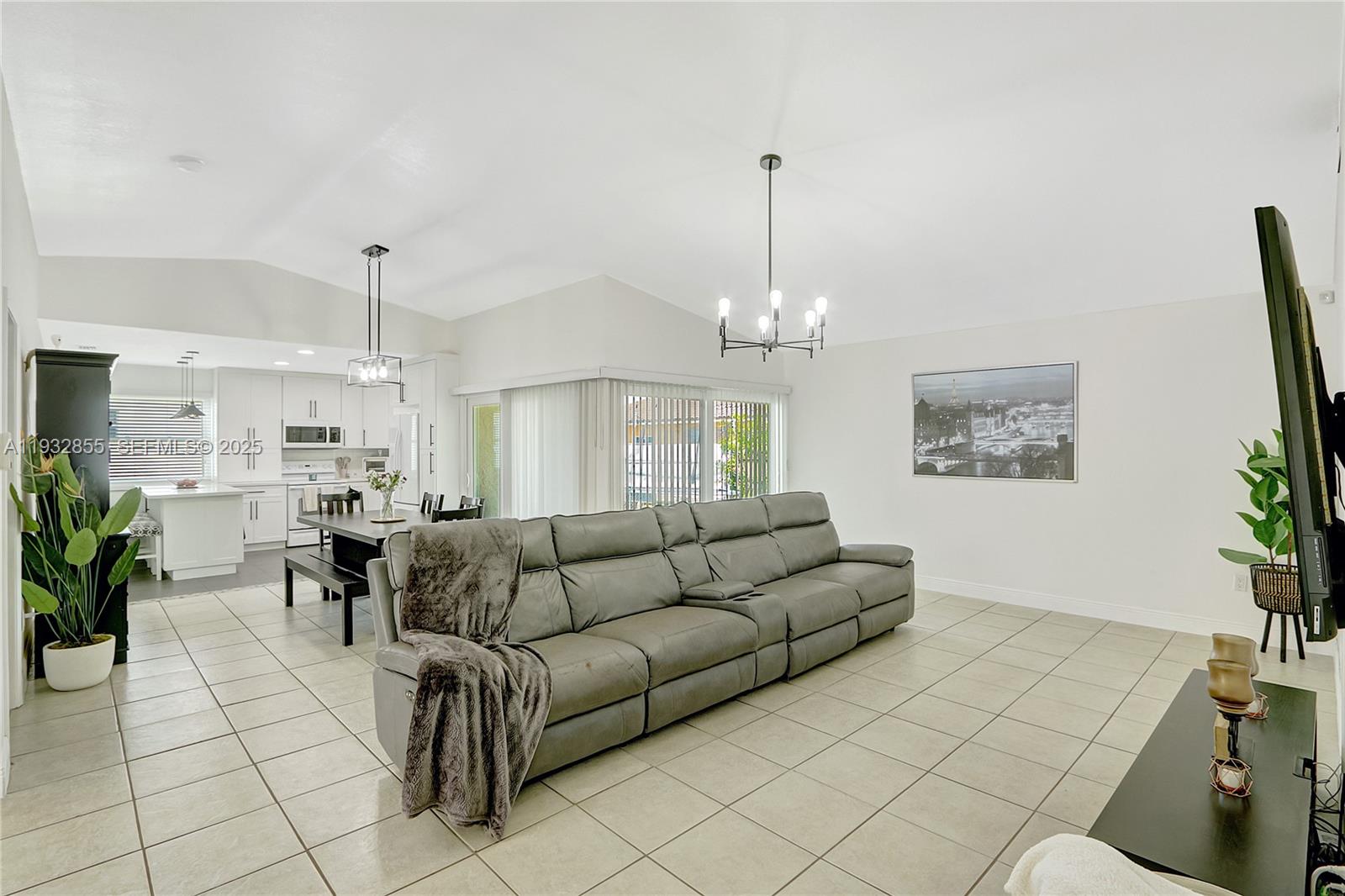 13217 Southwest 257th Terrace Homestead, FL 33032 - Photo 4 of 20 a living room with furniture and a chandelier