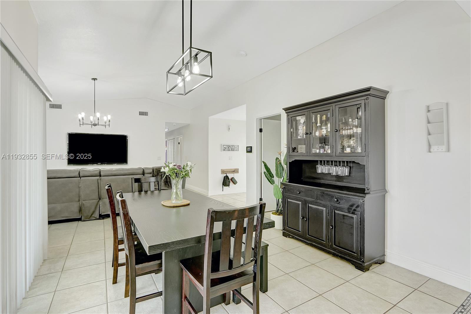 13217 Southwest 257th Terrace Homestead, FL 33032 - Photo 6 of 20 a view of a dining room with furniture and a flat screen tv