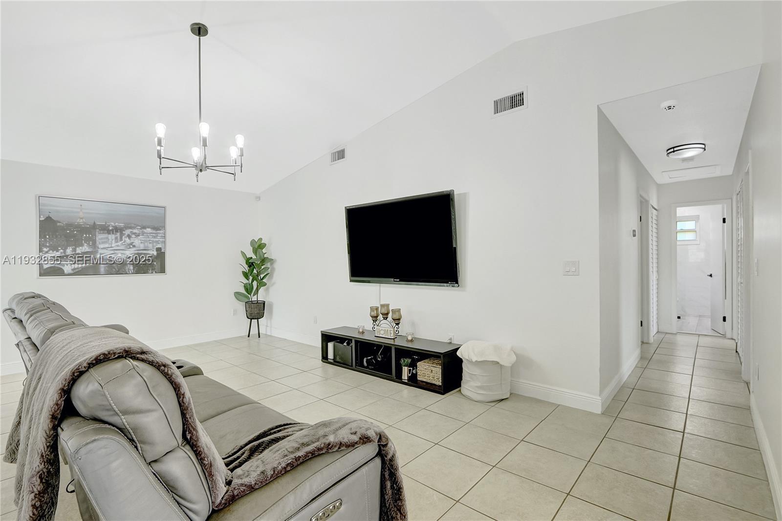 13217 Southwest 257th Terrace Homestead, FL 33032 - Photo 8 of 20 a living room with furniture and a flat screen tv