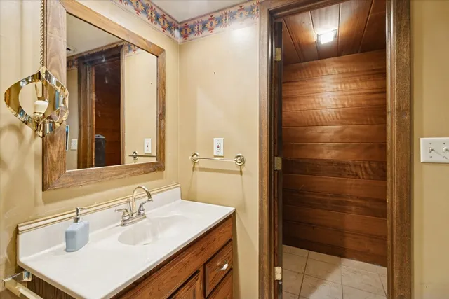 a bathroom with a sink shower and a mirror