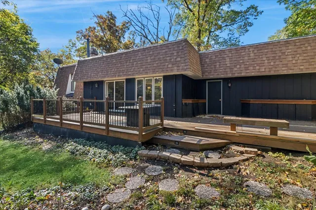a view of a house with backyard and sitting area
