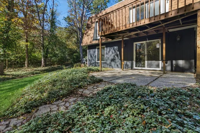 a view of a house with backyard and sitting area