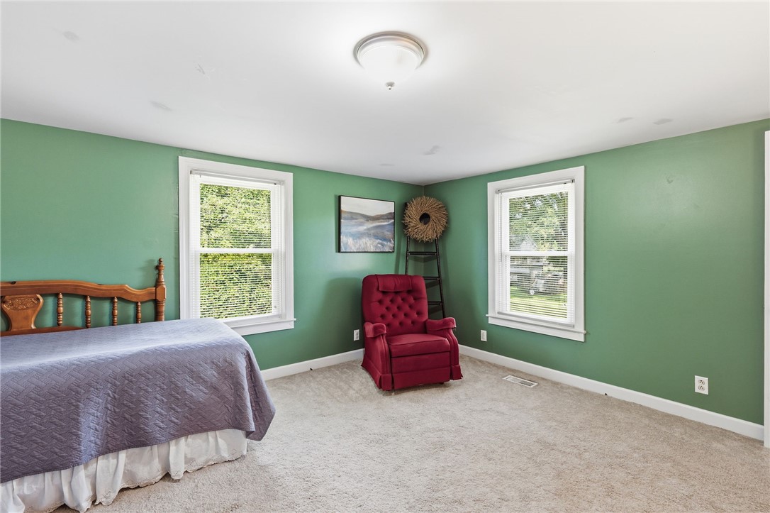108 Tarrant Street Central, SC 29630 - Photo 28 of 42 A tranquil sleeping space featuring soft carpeting and a bright window for natural illumination.