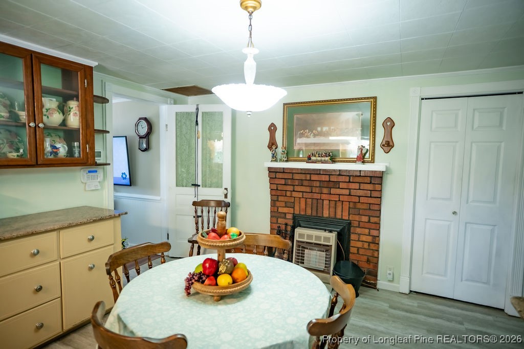 208 Thompson Street Fairmont, NC 28340 - Photo 11 of 19 a view of a dining room with furniture window and wooden floor