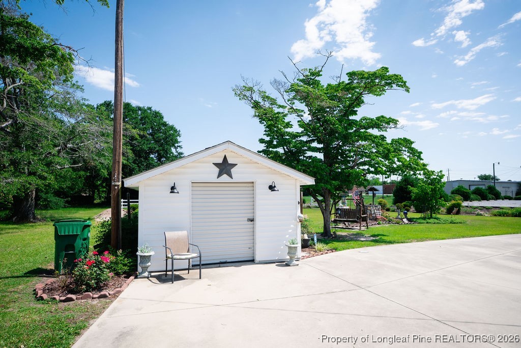 208 Thompson Street Fairmont, NC 28340 - Photo 16 of 19 a view of a house with yard and a garden