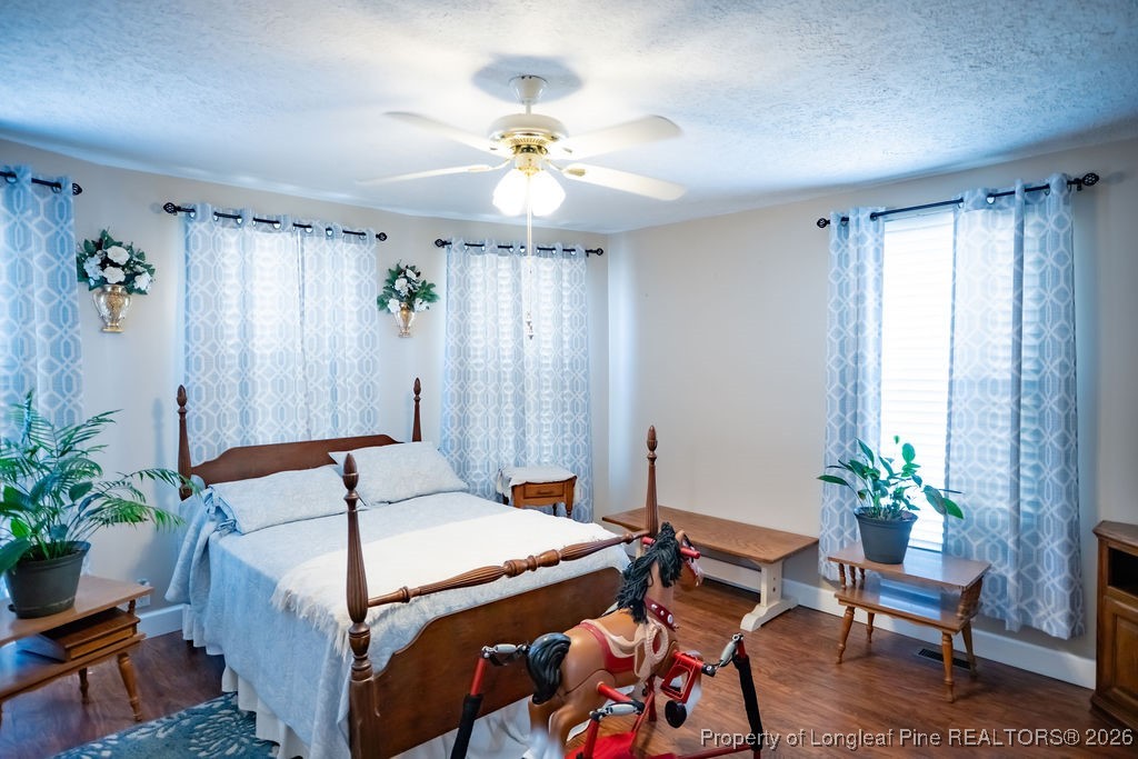 208 Thompson Street Fairmont, NC 28340 - Photo 5 of 19 a bedroom that has a bed and a chandelier