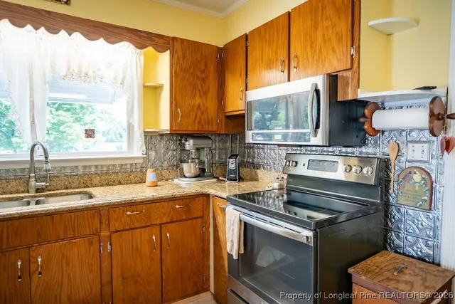 a kitchen with a sink stove and cabinets