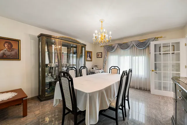a view of a dining room with furniture and chandelier
