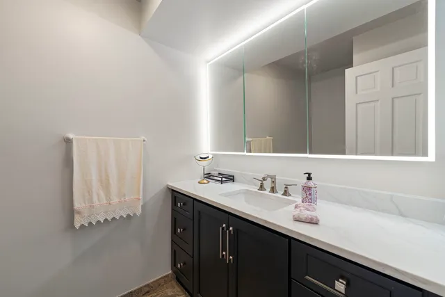 a bathroom with a sink and a mirror