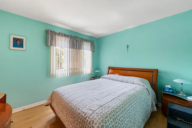 a bedroom with a bed and window