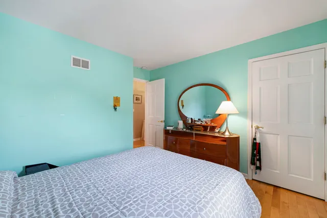 a bedroom with a bed and a dresser