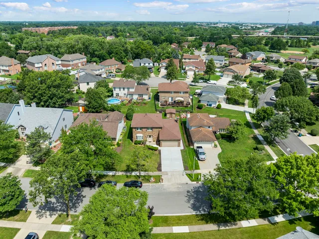 an aerial view of residential houses with outdoor space and street view