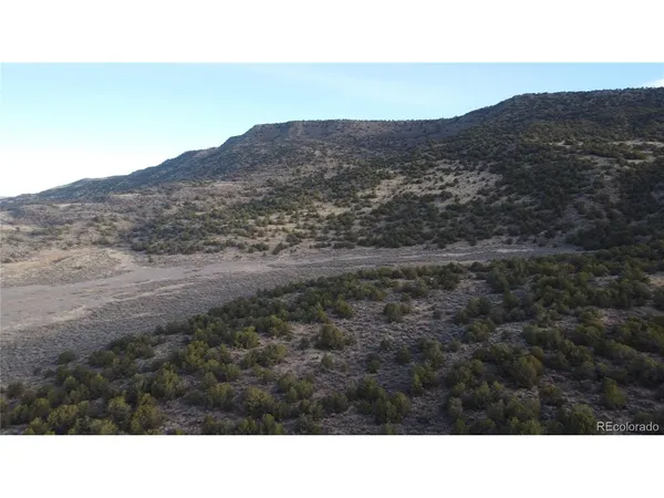 a open area with mountains in the background