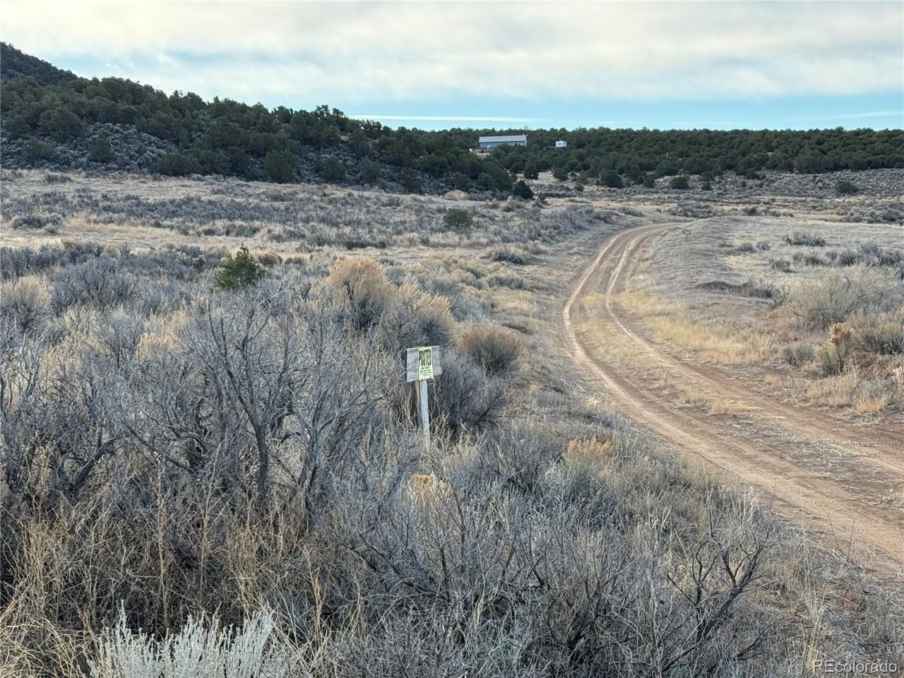 54 Old Stage Coach Road San Luis, CO 81152 - Photo 5 of 20 a view of a dry yard with wooden fence