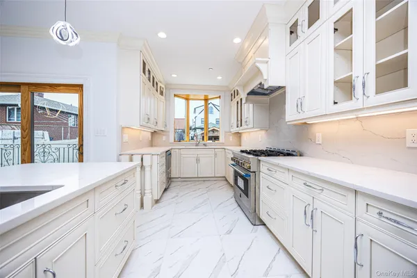 a kitchen with white cabinets and white appliances
