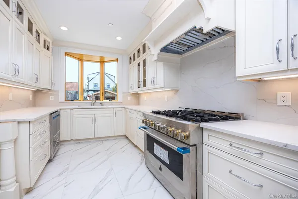 a kitchen with a stove a sink and a window