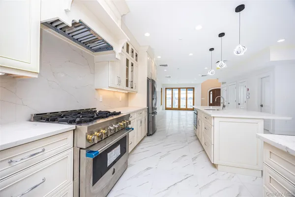a kitchen with granite countertop a stove and a sink