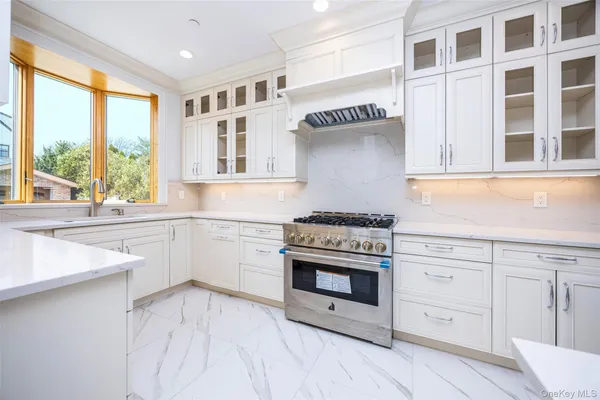 a kitchen with stainless steel appliances granite countertop a stove and a sink