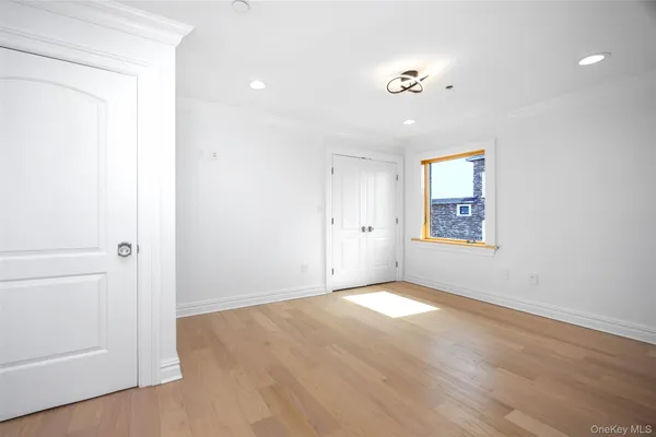 an empty room with windows and closet
