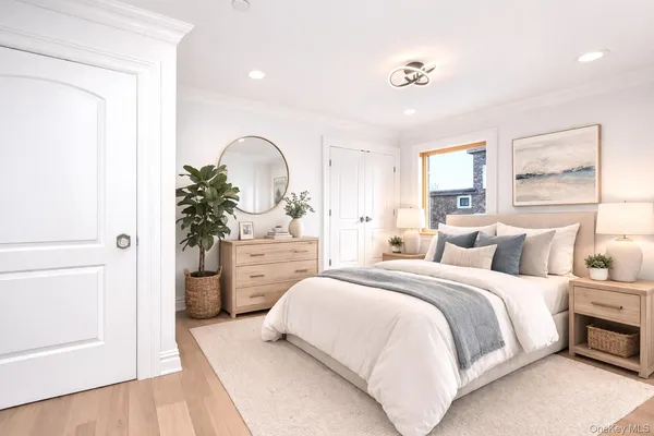 a bedroom with a bed and a potted plant