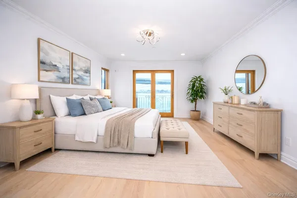 a spacious bedroom with a large bed and a chandelier