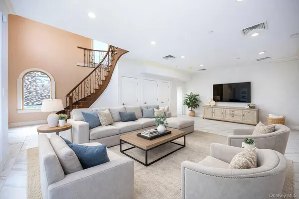 a living room with furniture and a flat screen tv