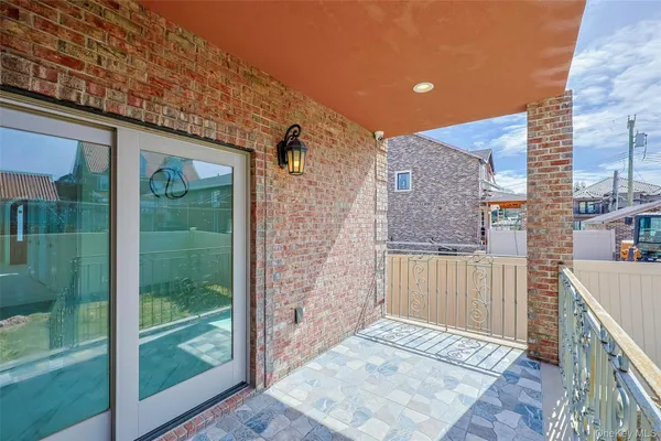 a view of a brick house with a large window