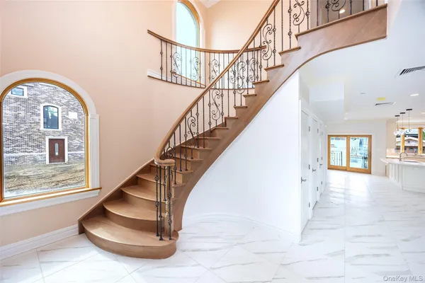 a view of entryway and hall with wooden floor