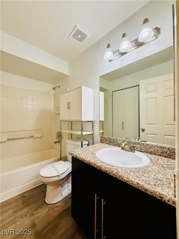2750 South Durango Drive, Unit 2010 Las Vegas, NV 89117 - Photo 21 of 31 Full bath with shower / bath combination, dark wood-type flooring, and vanity