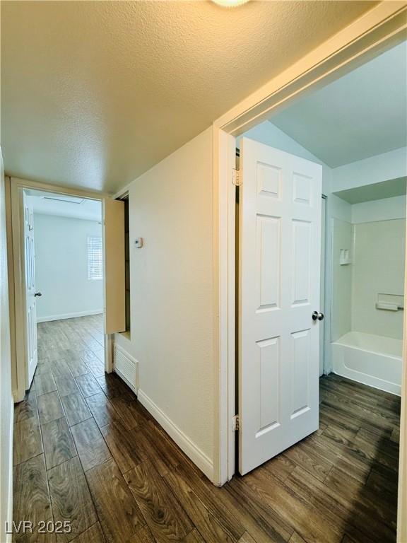 2750 South Durango Drive, Unit 2010 Las Vegas, NV 89117 - Photo 23 of 31 Hall with a textured ceiling and dark wood finished floors