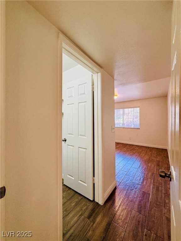 2750 South Durango Drive, Unit 2010 Las Vegas, NV 89117 - Photo 24 of 31 Hallway with dark wood-style floors and baseboards