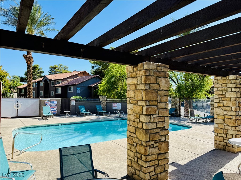 2750 South Durango Drive, Unit 2010 Las Vegas, NV 89117 - Photo 26 of 31 Community pool featuring a patio area and a pergola