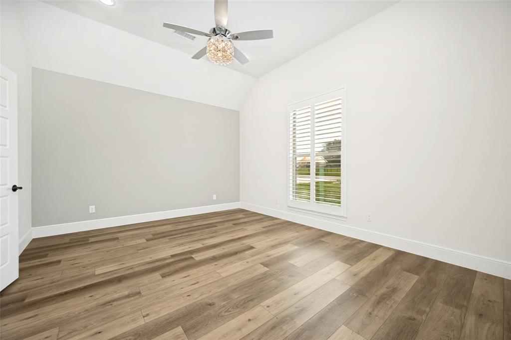 444 Ben Boyd Road Argyle, TX 76226 - Photo 16 of 28 a view of an empty room with wooden floor and a window