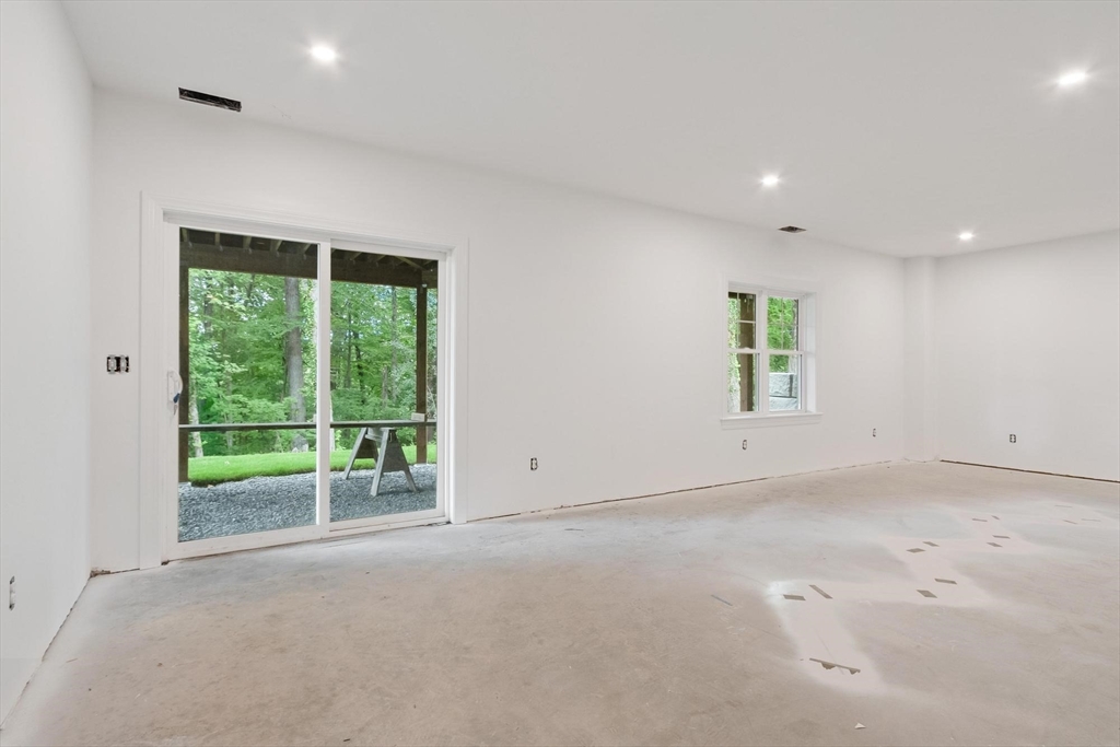 37 Dogwood Road Littleton, MA 01460 - Photo 17 of 36 an empty room with floor to ceiling windows and yard