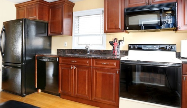 1 Taylor Road Billerica, MA 01821 - Photo 4 of 12 a kitchen with granite countertop stainless steel appliances and wooden cabinets