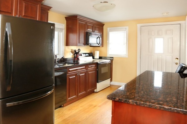 1 Taylor Road Billerica, MA 01821 - Photo 5 of 12 a kitchen with stainless steel appliances granite countertop a refrigerator a stove and a sink