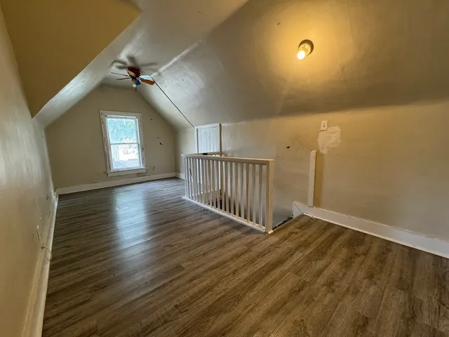 wooden floor in a hall with a window
