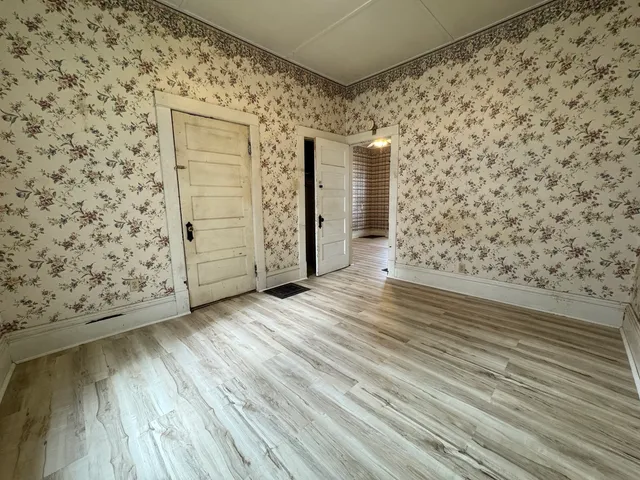 a view of wooden floor with brick walls