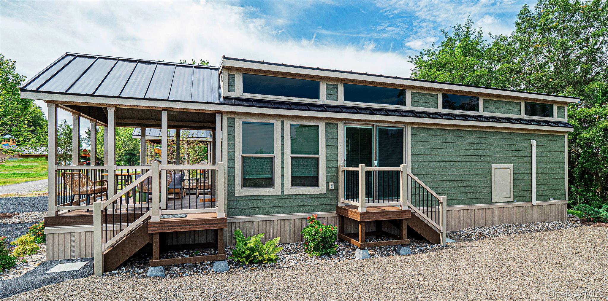 197 Wheeler Road, Unit 91 Florida, NY 10921 - Photo 21 of 48 View of side with a metal roof, a porch, and a wooden deck