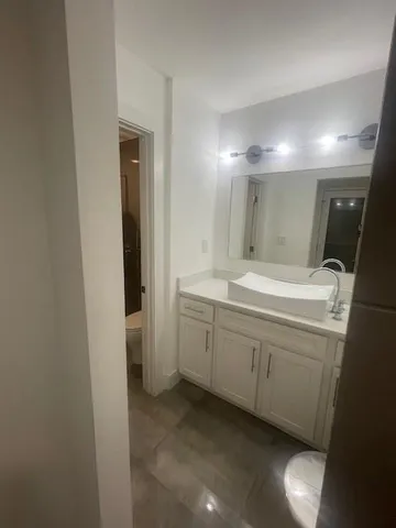 a bathroom with a double vanity sink and a mirror
