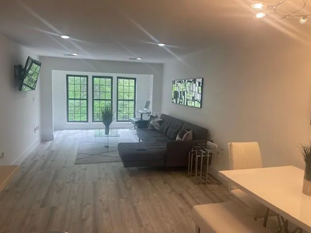 a living room with furniture and a large window