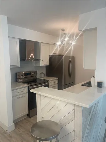 a kitchen with a sink a stove and refrigerator